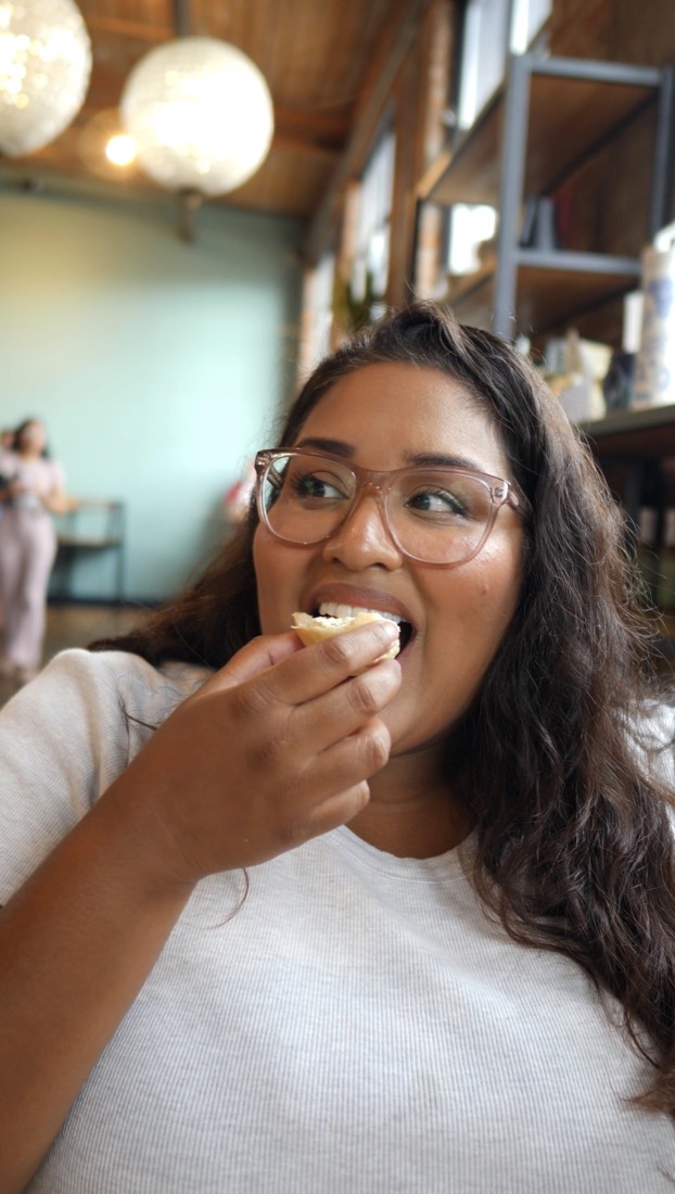 Stephanie taking a bite at a cafe